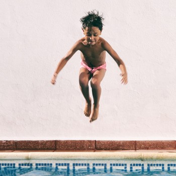 Boy jumping in pool